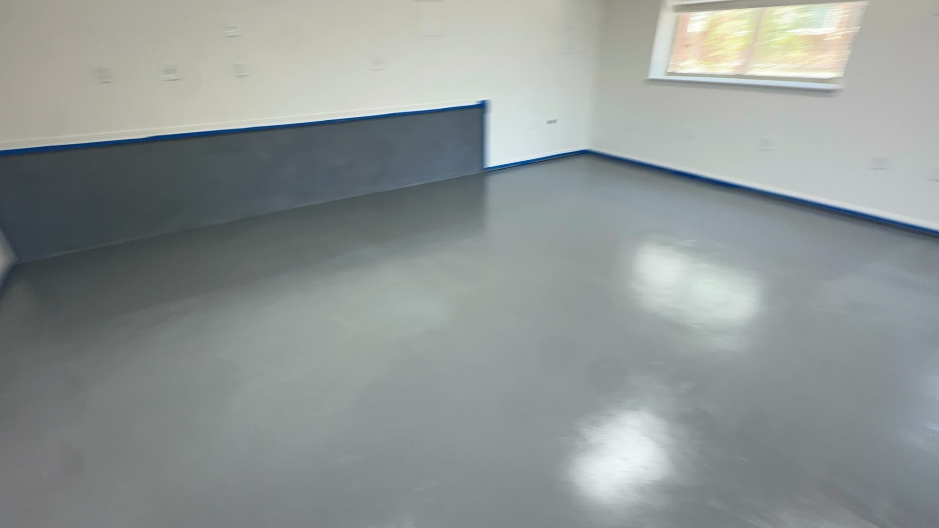 Smooth gray basement floor coating installed by Cornerstone Epoxy