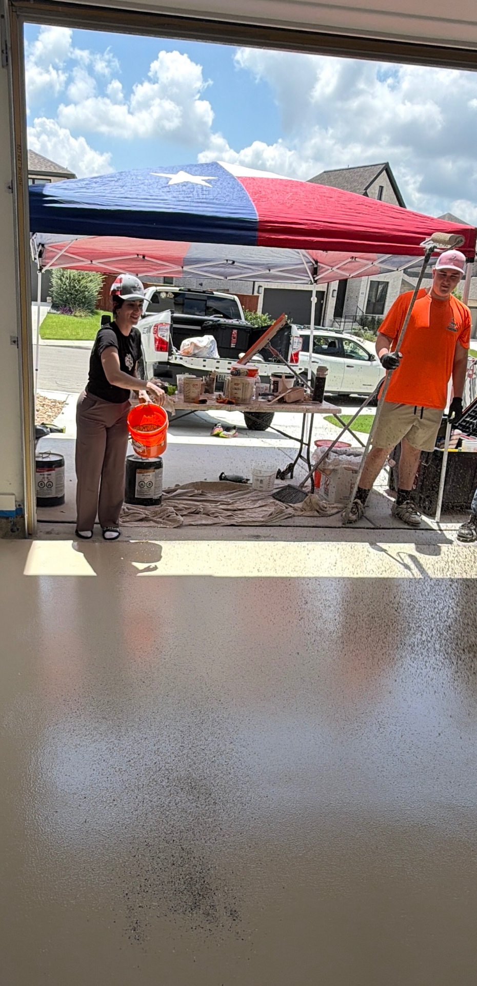 Cornerstone Epoxy crew working under Texas flag tent